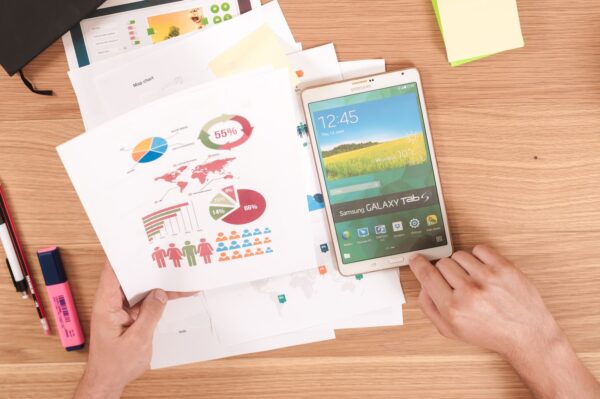 person holding white Samsung Galaxy Tab